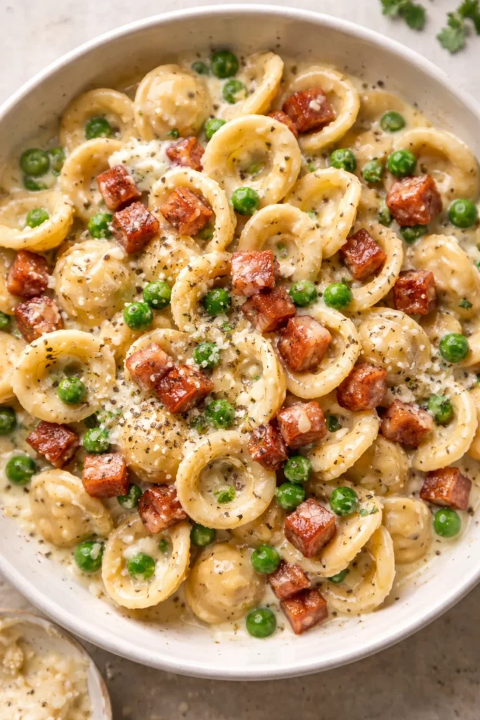 Orecchiette with crispy pancetta and peas in cream sauce on a plate